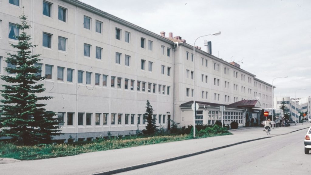 A large white building sitting on the side of a road