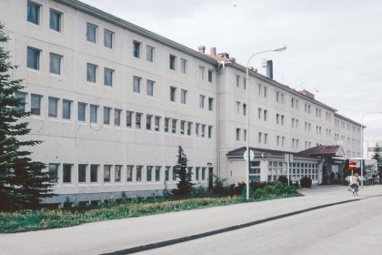 A large white building sitting on the side of a road
