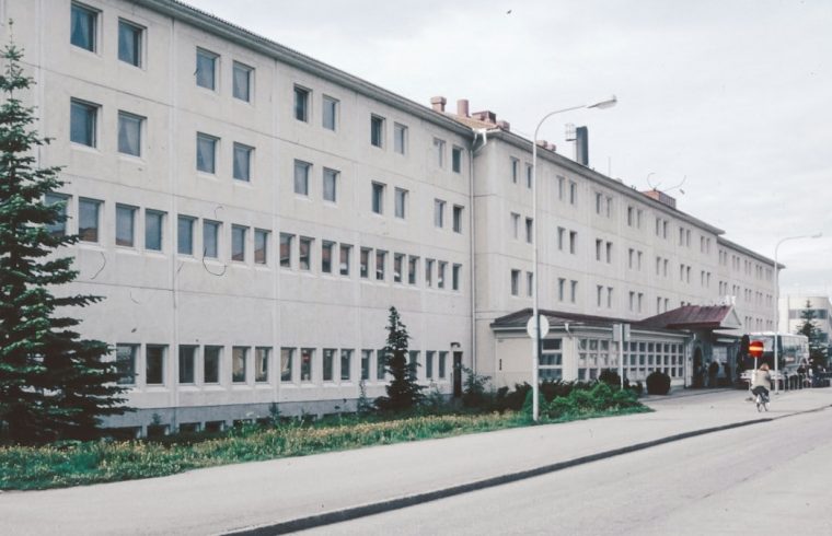 A large white building sitting on the side of a road